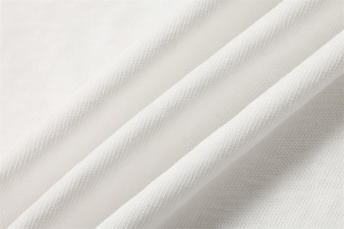 Close-up of the white shirt fabric showing its fine woven texture and soft drape