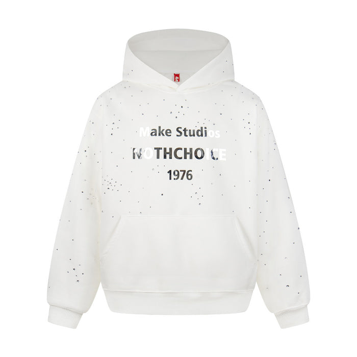Front view of a white oversized pullover hoodie with rhinestone splatter, kangaroo pocket, and 1976 chest print