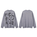 Gray distressed knit sweater shown front and back, with black abstract lettering on the front and a frayed hem