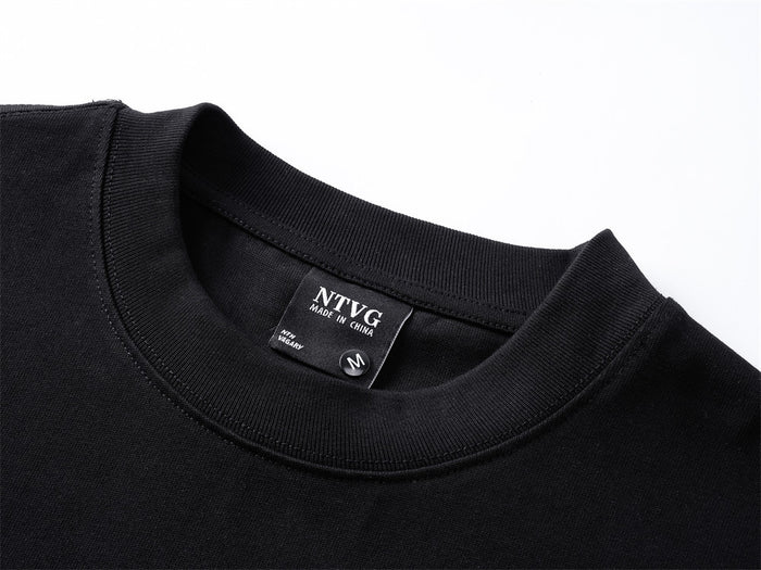 Close-up of the black shirt’s ribbed crew neckline and sewn-in size label