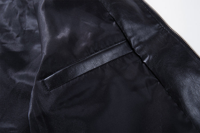 Interior close-up of the black jacket showing the dark lining, inner seam, and zipper edge