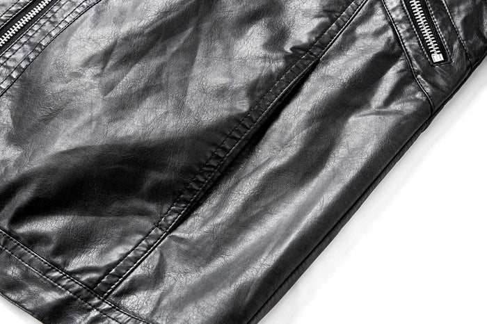 Close-up of the black PU leather jacket lower front and sleeve showing glossy texture and stitched seams