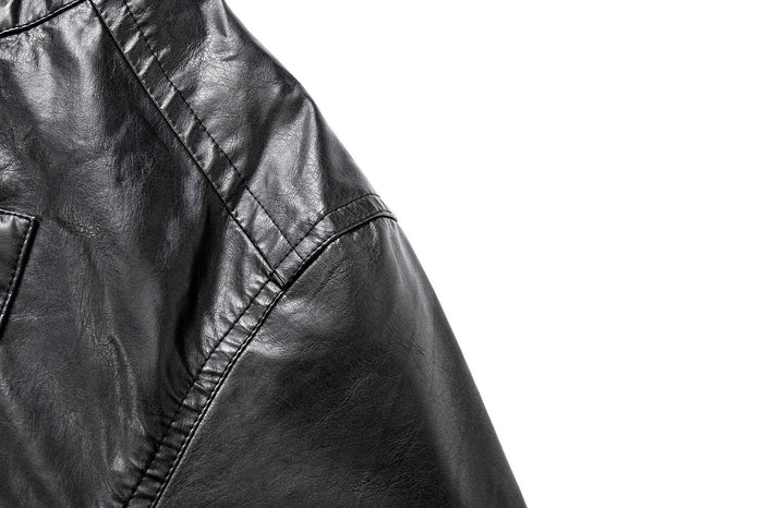 Close-up of the black jacket shoulder and upper sleeve showing stitched panel construction