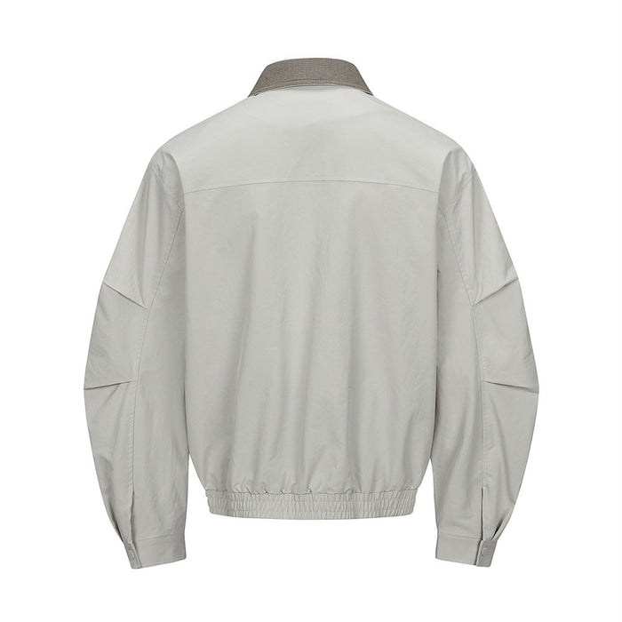 Light gray bomber jacket shown from the back with a brown houndstooth collar and gathered hem