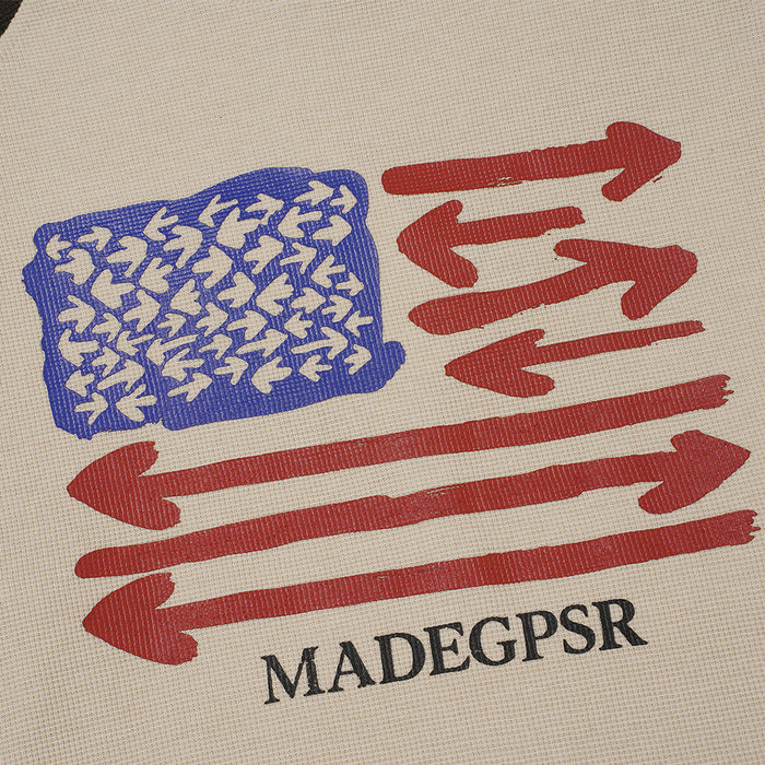 Close-up of the blue and red arrow graphic printed on beige waffle-knit fabric