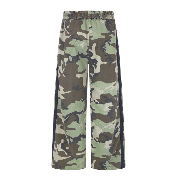Back view of green and brown camouflage wide-leg sweatpants with navy side stripes