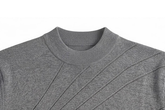 Close-up of the gray sweater's ribbed crew neckline and radiating raised knit lines