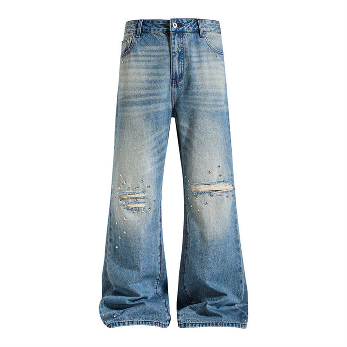 Front view of washed blue wide-leg flare jeans with distressed knees and scattered silver studs