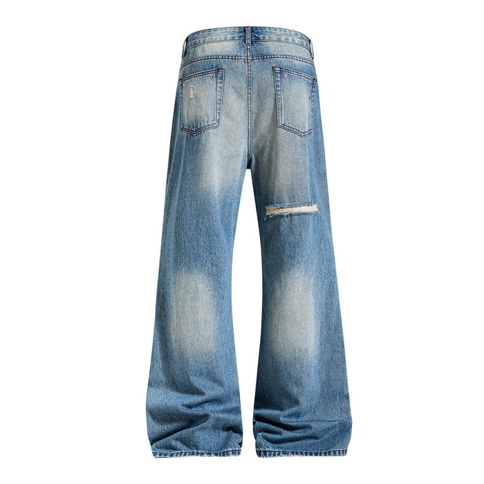 Back view of washed blue wide-leg jeans with two pockets and a distressed tear on the right leg