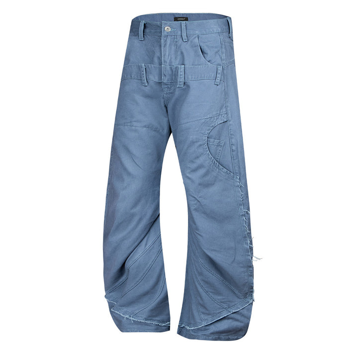 Angled front view of blue wide-leg pants showing curved seams, side utility pockets, and a raw hem edge
