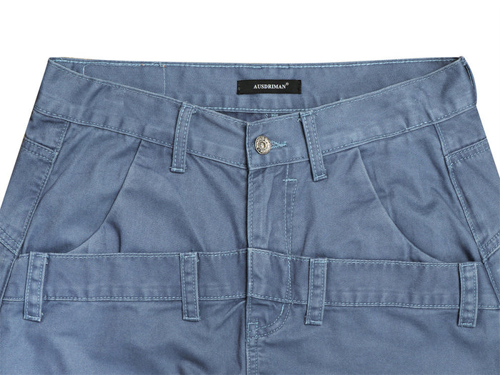 Close-up of the blue pants waistband showing belt loops, button closure, slanted front pockets, and utility loops
