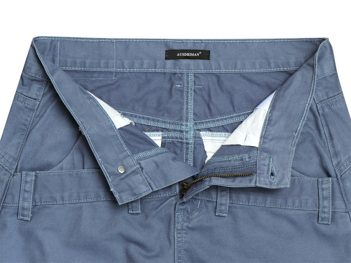 Opened waistband close-up showing the blue pants zipper, inner lining, button closure, and layered waistband construction