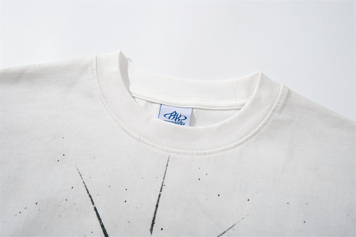 Close-up of the white T-shirt's ribbed crew neckline, inner label, and partial figure graphic