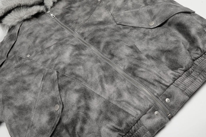 Angled close-up of the grey bomber jacket front showing flap pockets, zipper, snaps, and ribbed hem