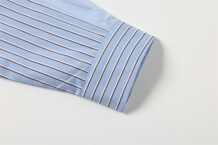 Close-up of the light blue striped shirt sleeve ending in a folded cuff