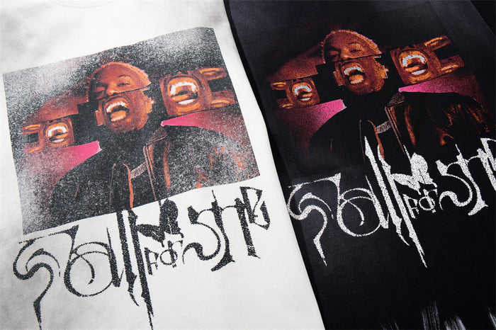 Close-up comparison of white and black shirt fronts showing matching portrait artwork and large stylized lettering