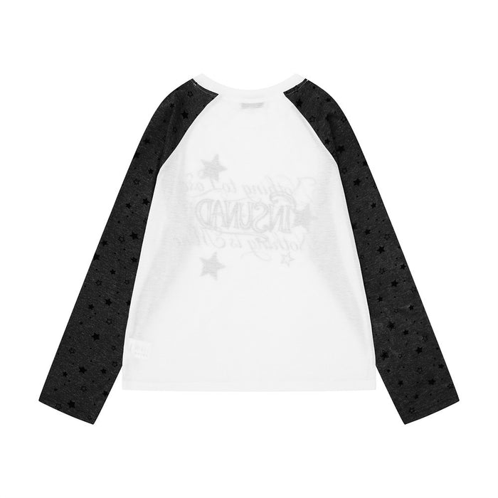 Back view of a white raglan shirt with black star-print sleeves and a faint reversed front graphic