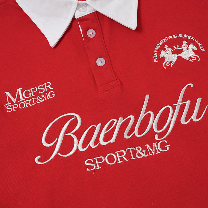 Red polo shirt chest close-up with white embroidered script lettering, crest, and sports text below the placket