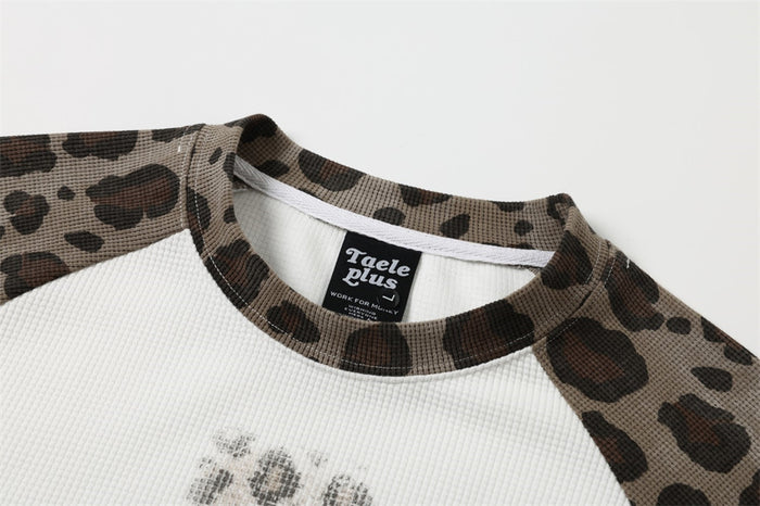 Close-up of the shirt's leopard-print raglan neckline and textured white waffle-knit body