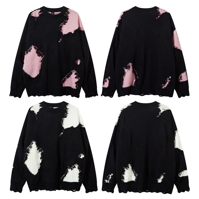 Black distressed knit sweater shown in front and back views with pink and white colorblock patches
