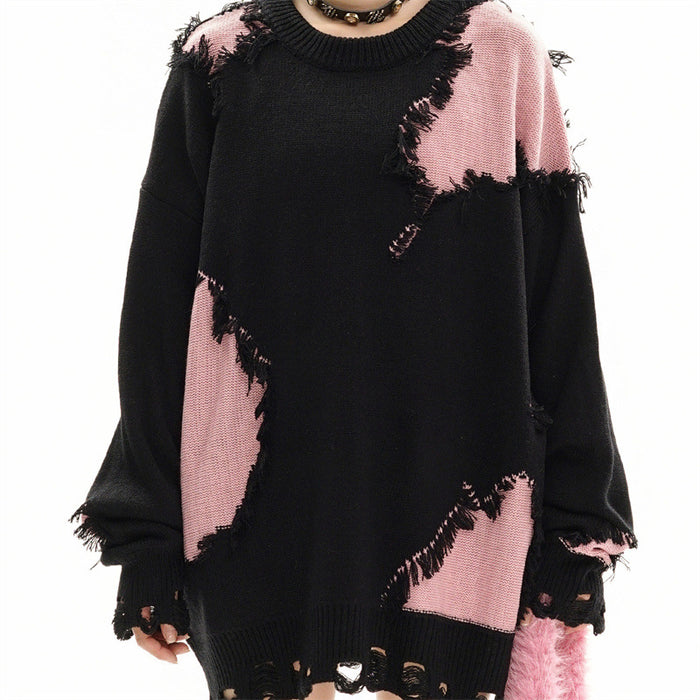 Front model view of a black knit sweater with pink distressed patches and raw fringed edges