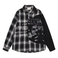 Front view of a gray-black plaid button-up shirt with black sleeves, white text, and a distressed skull graphic