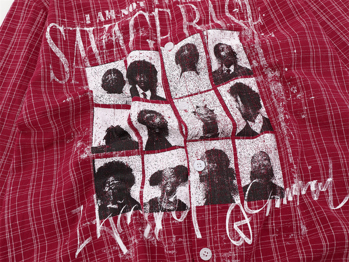 Close-up of the red plaid shirt's distressed white portrait grid graphic and front buttons