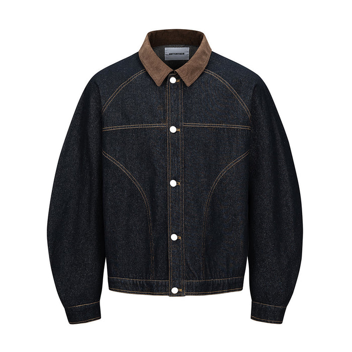 Men's raw indigo denim jacket with brown corduroy collar and deconstructed curved seam paneling, front view
