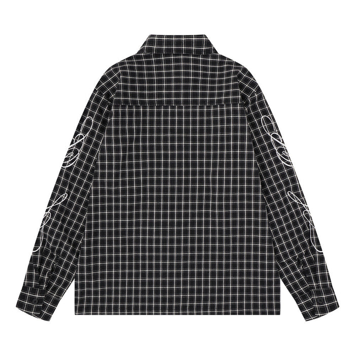 Back view of a black plaid long-sleeve button-up shirt with white graphic details on both sleeves