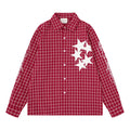 Front view of a red plaid long-sleeve button-up shirt with four white star patches on the chest