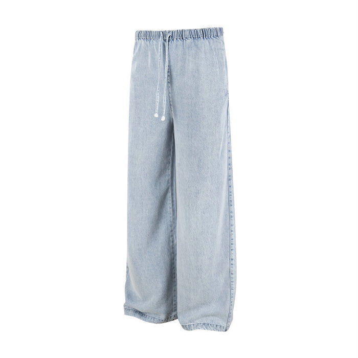 Angled front view of light wash wide-leg denim pants with an elastic drawstring waistband and loose legs