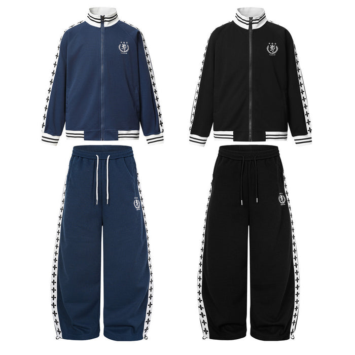 Front view of navy and black waffle-knit track jacket and wide-leg sweatpants sets with white cross-print side tape