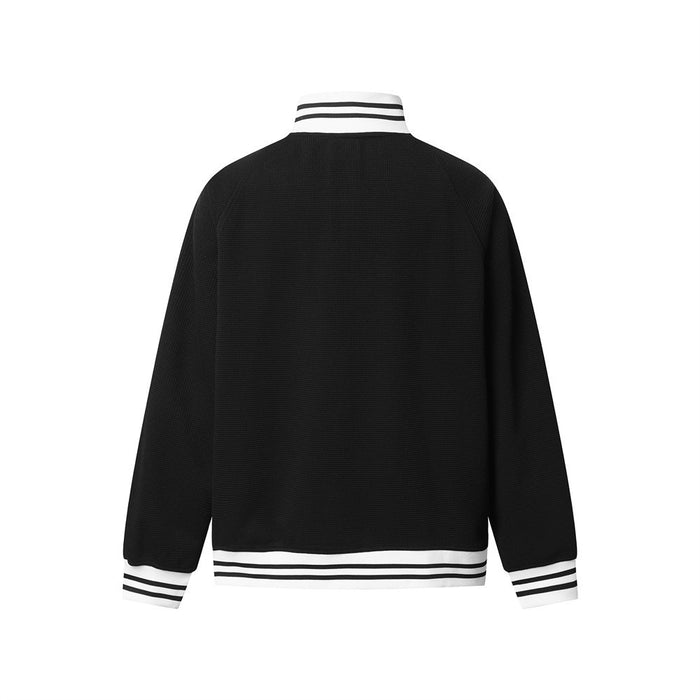 Back view of a black waffle-knit track jacket with striped white collar, cuffs, and hem