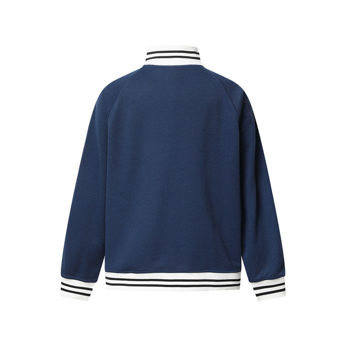 Back view of a navy waffle-knit track jacket with striped white collar, cuffs, and hem