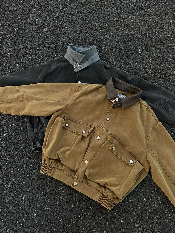 Brown and black bomber jackets arranged in a flat lay, showing the brown jacket front, cargo pockets, and collars