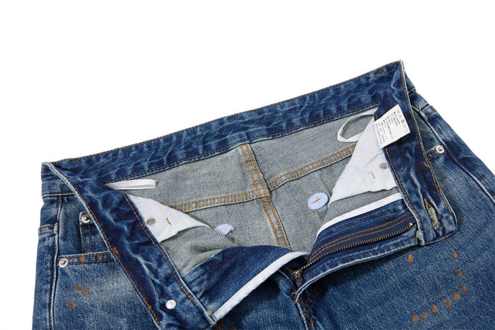 Open waistband and fly showing the inside construction, pocket lining, and attached clothing labels