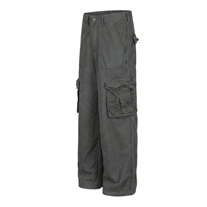Angled side view of dark gray wide-leg cargo pants showing layered cargo pockets and relaxed straight fit