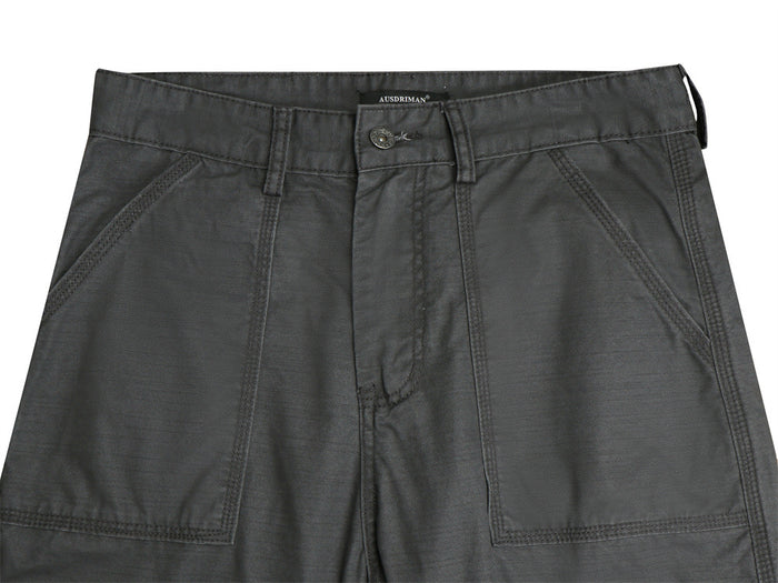 Close-up of dark gray cargo pants waistband, button closure, belt loops, fly, and angled front pockets