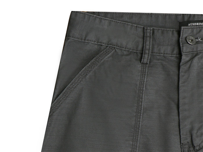 Close-up of a dark gray cargo pants front slant pocket with reinforced double stitching