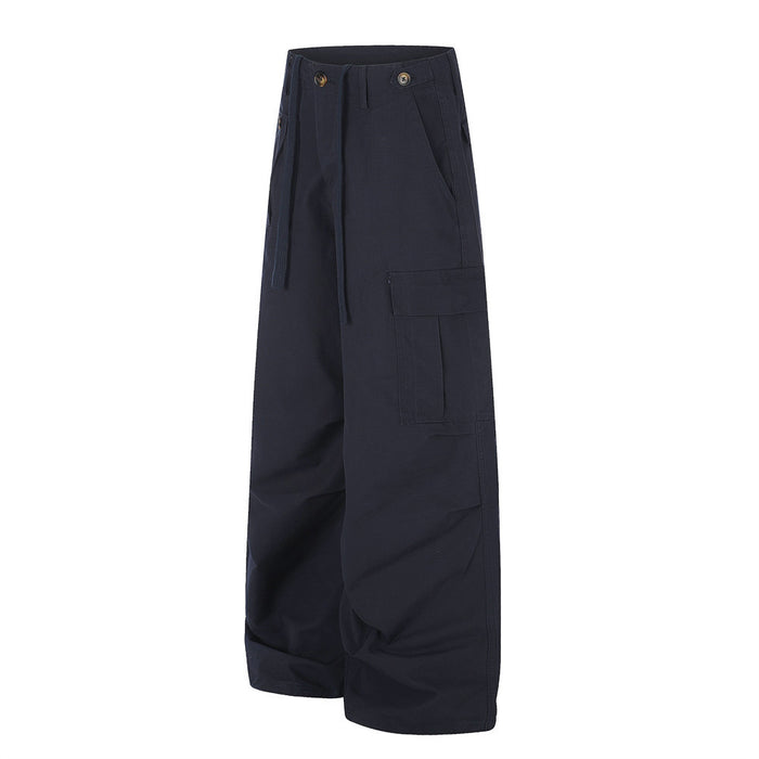 Angled front view of navy wide-leg cargo pants showing the side cargo pocket and drawstring waist