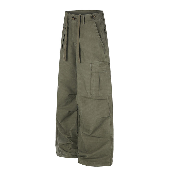 Angled front view of olive green cargo pants showing the side cargo pocket and drawstring waist