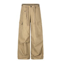 Front view of khaki wide-leg cargo pants with drawstring waist, multiple pockets, and straight hems