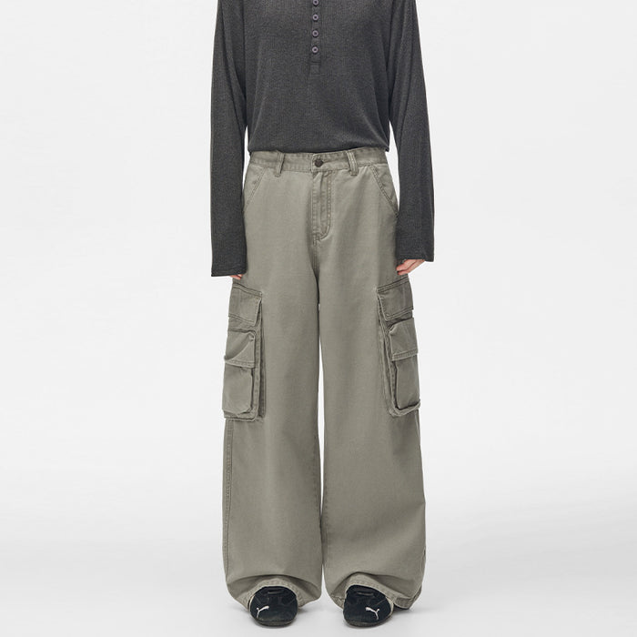 Front view of gray-green wide-leg cargo pants with large layered thigh pockets and relaxed fit