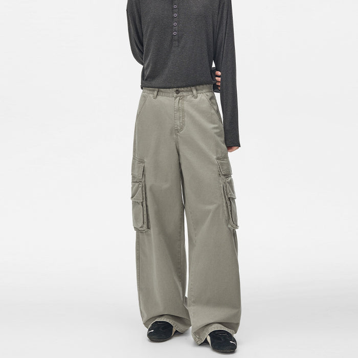 Front model view of gray-green cargo trousers with button waist, hand pockets, and wide legs