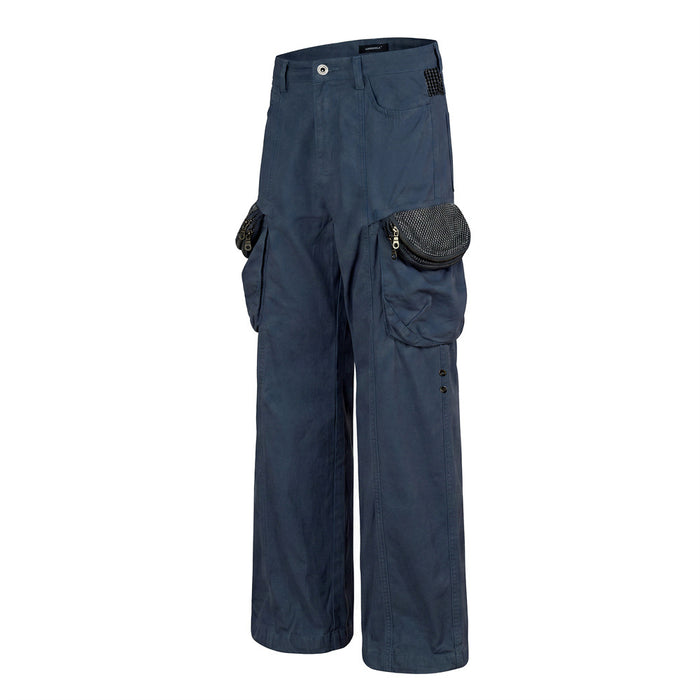 Navy wide-leg cargo pants in an angled front view showing layered cargo pockets and textured patterned pocket flaps