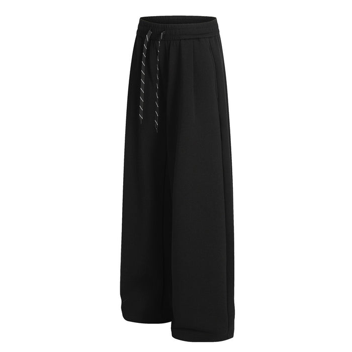 Black wide-leg sweatpants shown from a side angle with a loose fit and front drawstrings