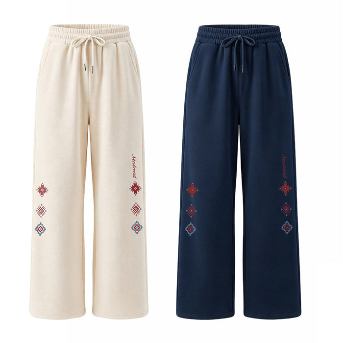 Wide-leg sweatpants in cream and navy with elastic waists, drawstrings, and colorful geometric leg motifs