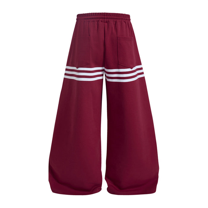 Burgundy wide-leg sweatpants back with two pockets and triple white stripe bands across the legs