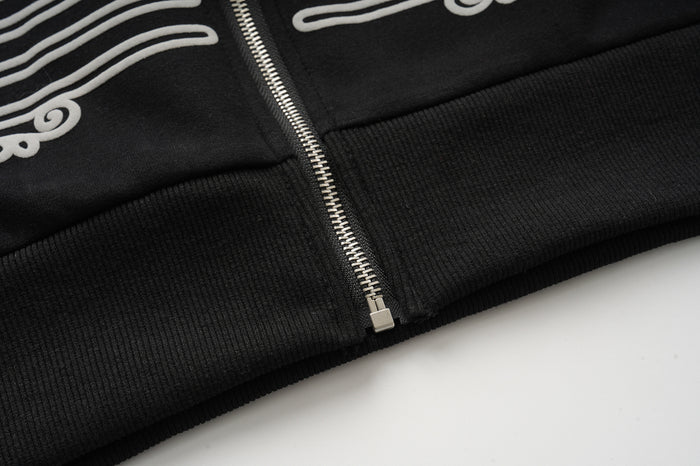 Lower front close-up showing the silver zipper ending above the ribbed black waistband