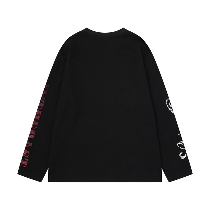 Black waffle-knit shirt back showing a plain body with contrasting sleeve graphics